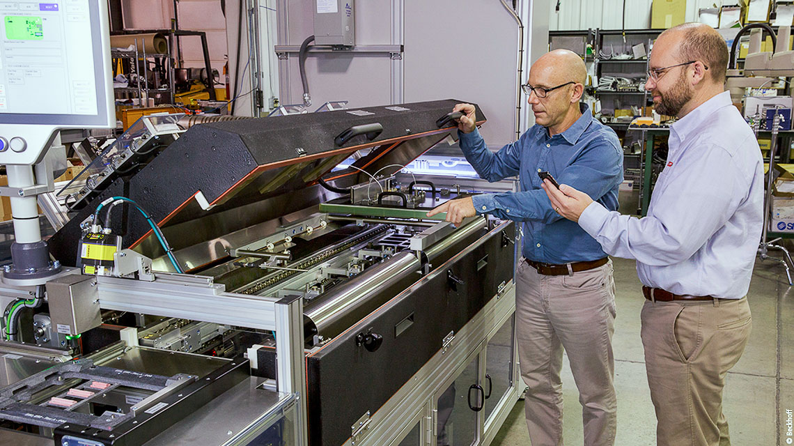 At the POV facility, D2 Engineering Owner and Senior Software Engineer Dan Distefano (left) and Beckhoff Regional Sales Engineer Casey Taylor inspect the new PCB test handler.  